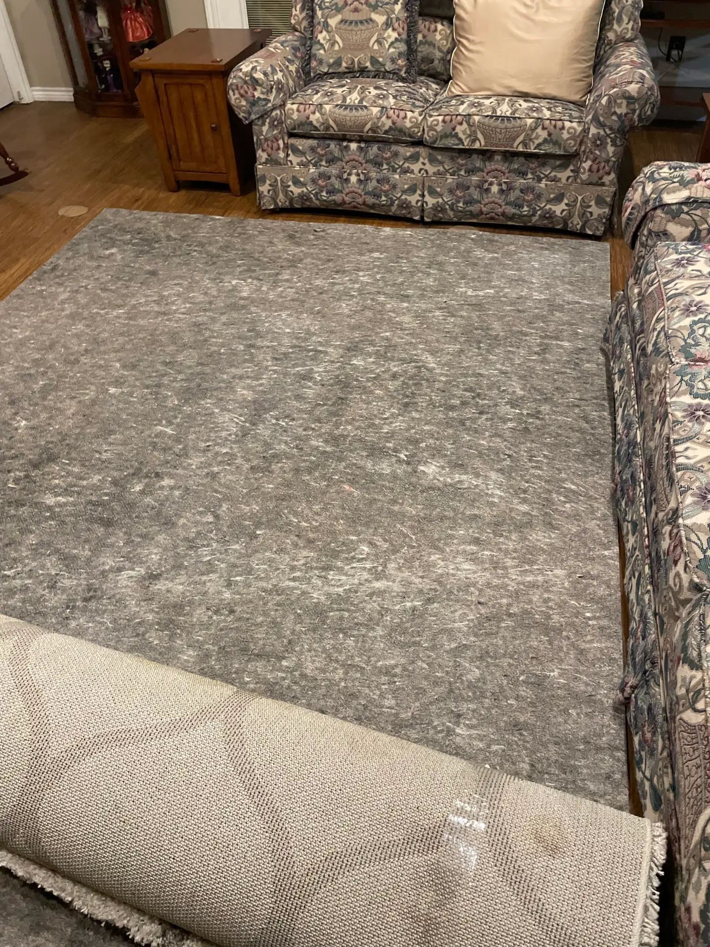 Premium rug placement in Dallas—unrolling and positioning with light furniture adjustment