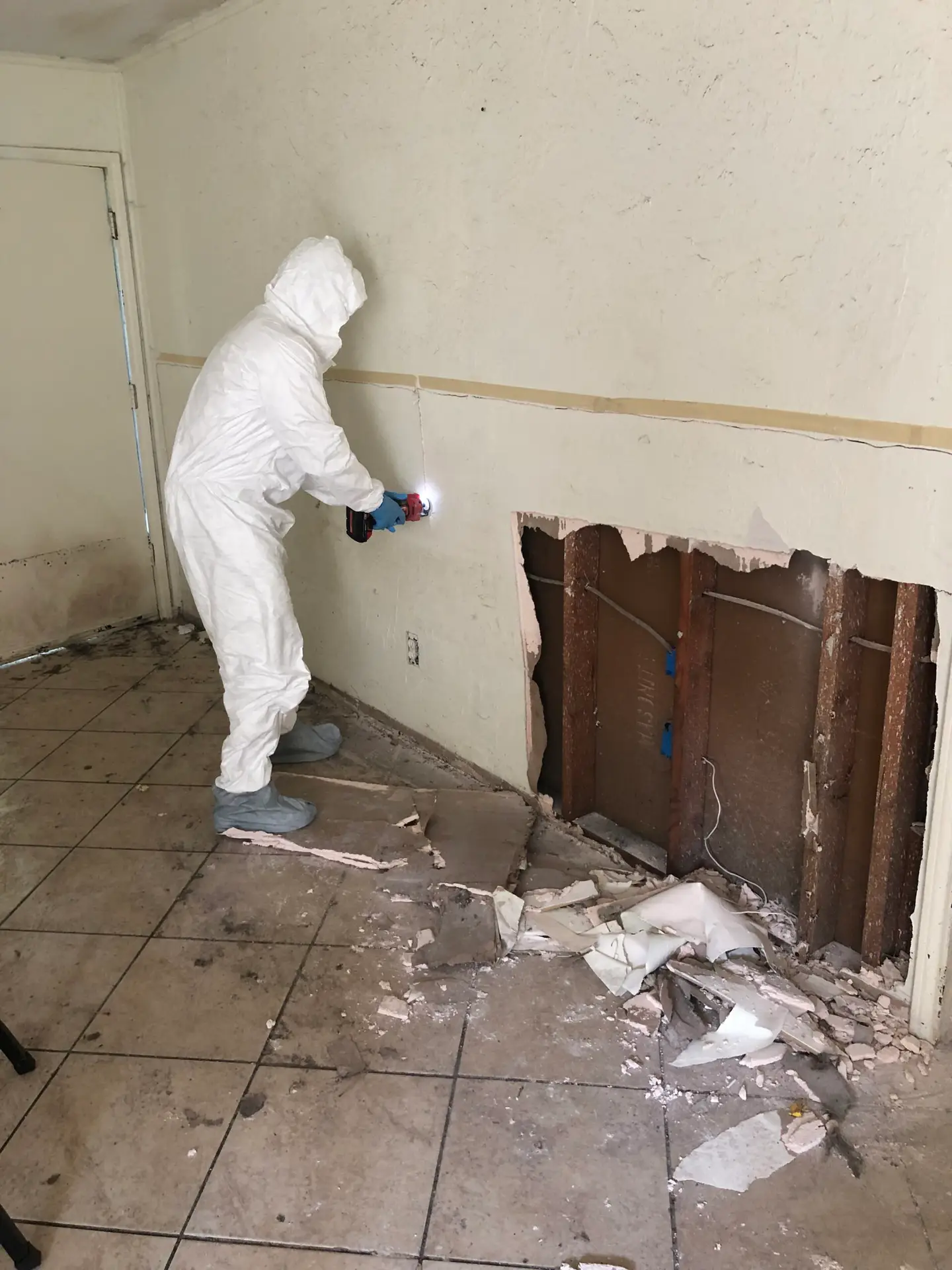 Dallas sewage cleanup technician with PPE and containment