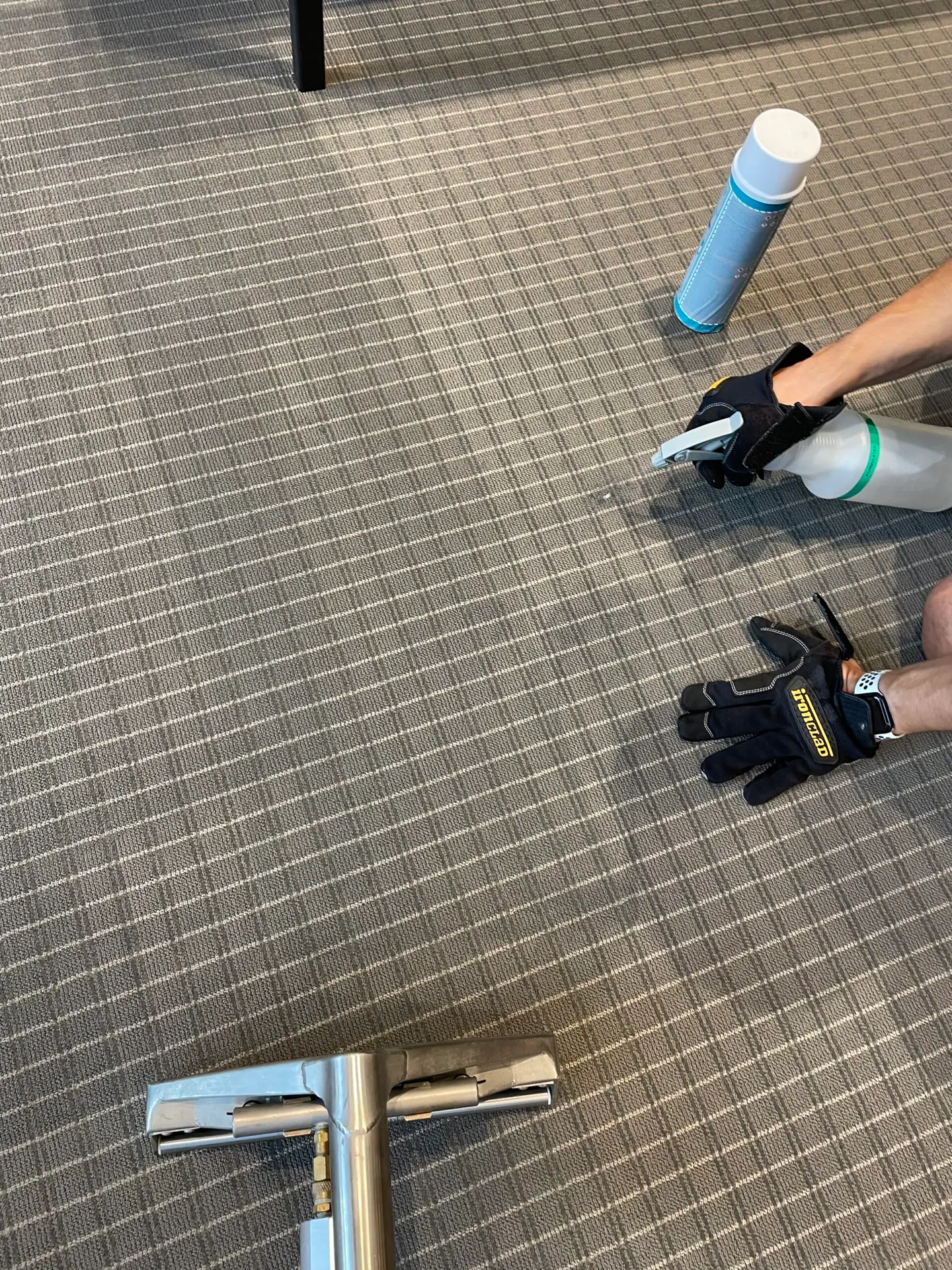 Dallas technician treating commercial coffee stain on carpet tile